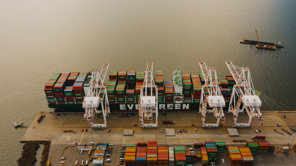 From above of many cargo containers on ship moored on calm water of river in daytime